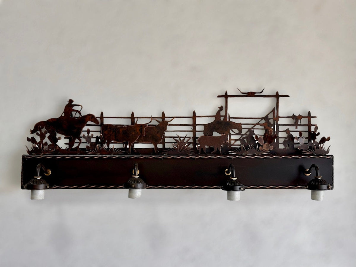 Western vanity light featuring cowboy,horse, and cattle in front of corral
