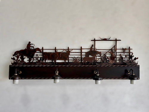 Western vanity light featuring cowboy,horse, and cattle in front of corral